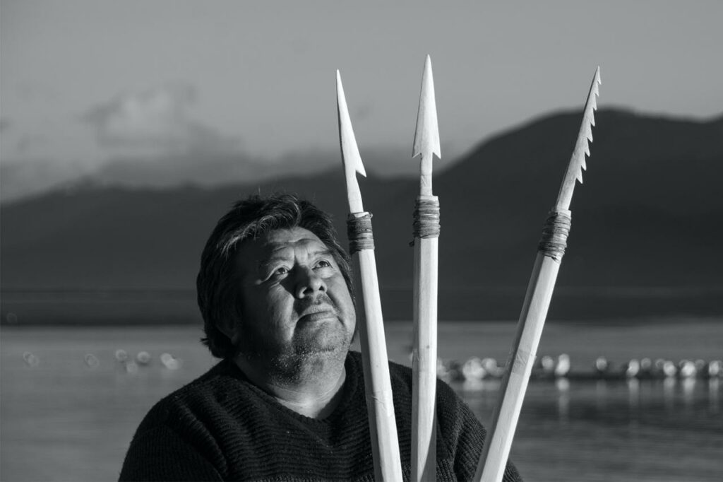 Portrait of José German Gonzalez Calderon, Yagan craftsmanship, with his creations: three whalebone harpoons (photograph by Omar Barroso)
